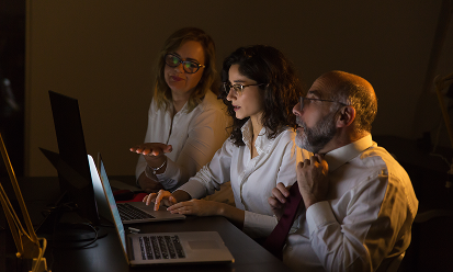 colleagues-discussing-work-dark-office